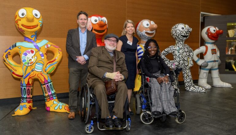 People in front of morph statues