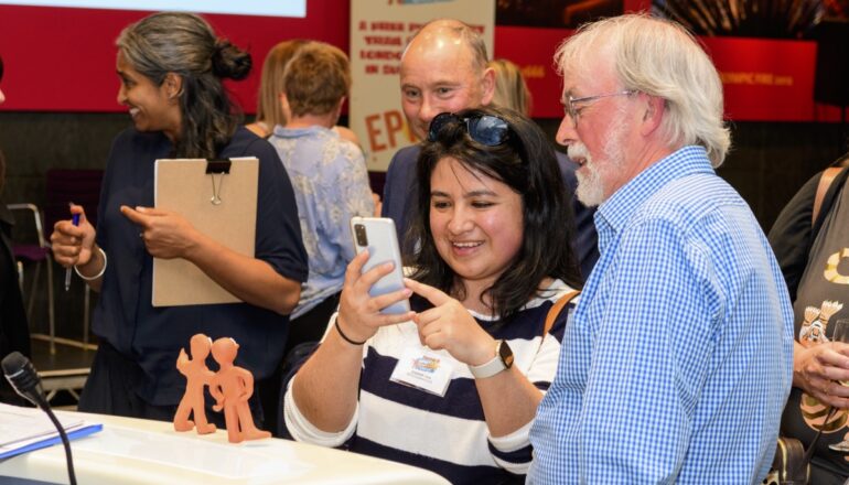 People taking images of small morphs statues