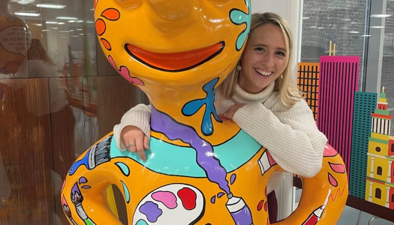 Person leaning on sculptures shoulders